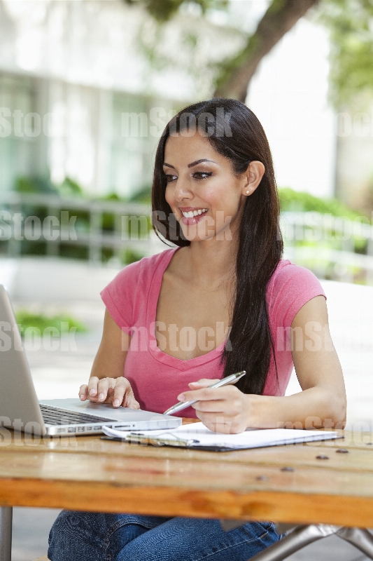 Mujer joven haciendo tarea en el Campus